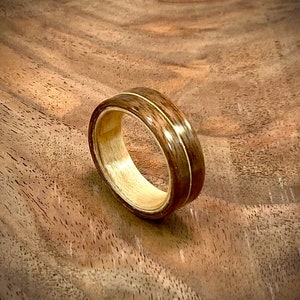 Walnut and maple handmade bentwood ring with guitar string inlay
