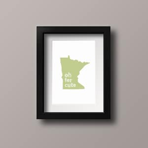 May include: A framed print of the state of Minnesota with the text "oh fer cute" inside the outline of the state.