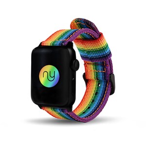 May include: Black smartwatch with a rainbow-striped band. The band features a vibrant spectrum of colors, including red, orange, yellow, green, blue, and purple. The watch face displays a circular logo with the letters "ny" in a rainbow gradient.