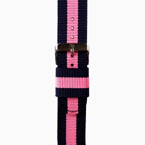 May include: A navy blue and pink striped watch strap with a silver buckle.