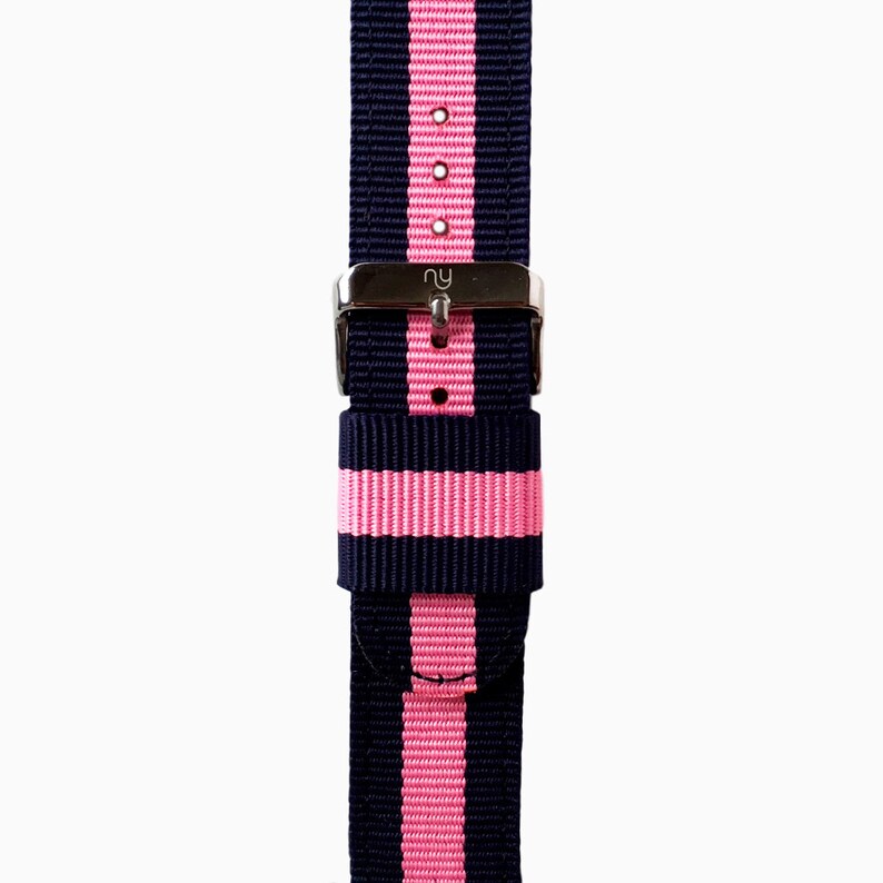 May include: A navy blue and pink striped watch strap with a silver buckle.