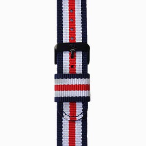 May include: A navy blue, white, and red striped watch strap with a black buckle.