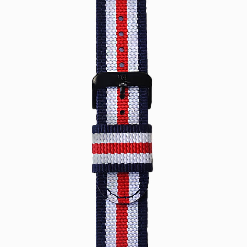 May include: A navy blue, white, and red striped watch strap with a black buckle.