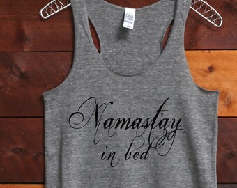 May include: Gray tank top with a black graphic that says "Namastey in bed".
