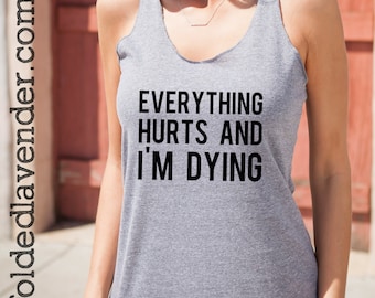 May include: Gray tank top with the text "EVERYTHING HURTS AND I'M DYING" printed in black.