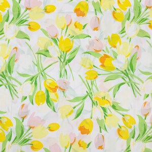 May include: A white fabric with a repeating pattern of yellow and pink tulips. The tulips are stylised and have a simple design.