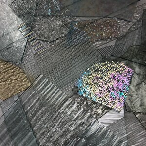 May include: A collection of textured glass sheets in various shades of gray, with one sheet featuring a rainbow iridescent pattern.