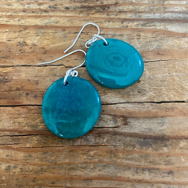 Gorgeous teal disc Tagua nut (vegetable Ivory) dangle earrings with sterling silver wires .