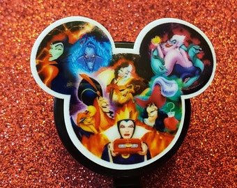 May include: A black retractable badge reel featuring a Mickey Mouse head design. The design showcases various Disney villains in a colorful collage against a red glitter background. The reel has a black cord and a clip.