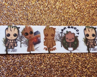 May include: White ribbon with a repeating pattern of a cartoon character with the text "I am Groot" and "I'm Groot".