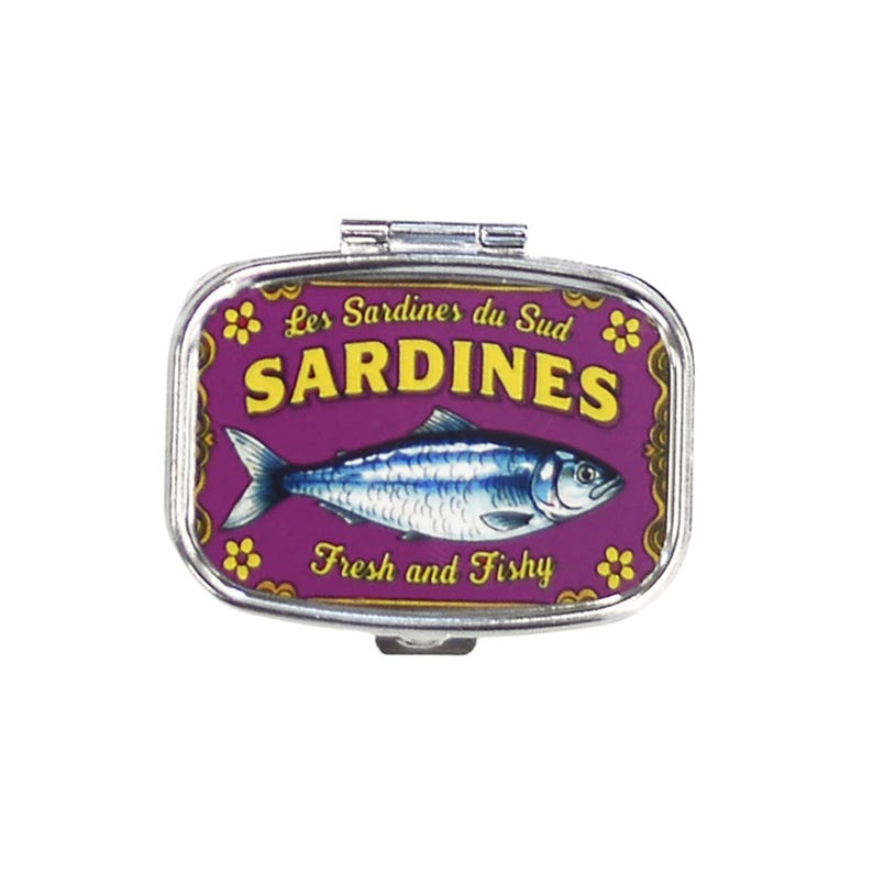 May include: A rectangular, hinged pill box with a purple background and a sardine illustration. The text "Les Sardines du Sud" and "SARDINES" are displayed in yellow. The phrase "Fresh and Fishy" is also visible.
