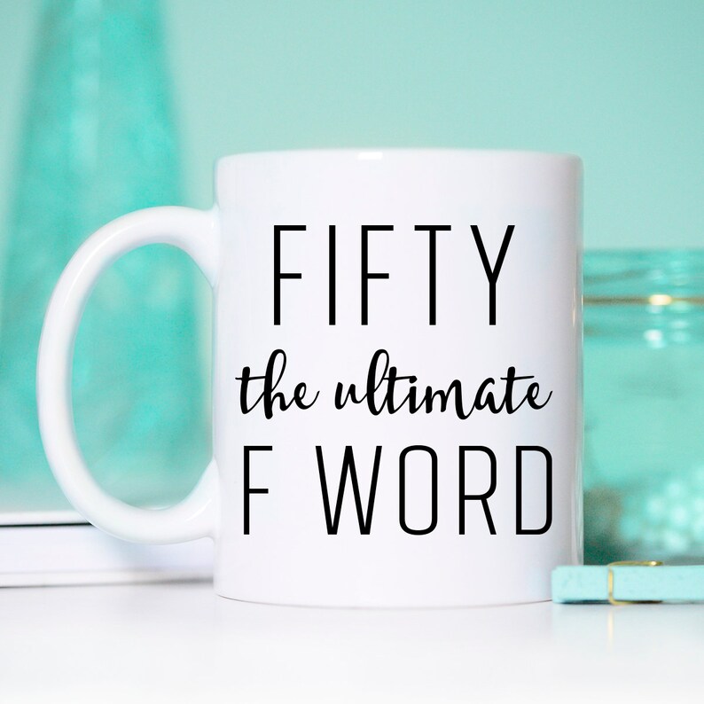 May include: White ceramic coffee mug with black text that reads "FIFTY the ultimate F WORD".