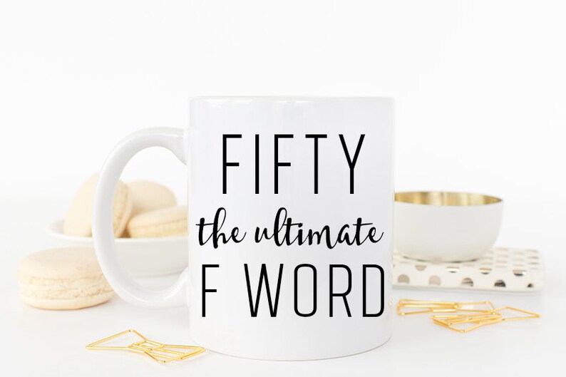 May include: White ceramic mug with black text that reads "FIFTY the ultimate F WORD".