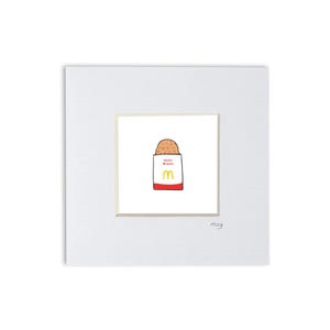 May include: A framed print featuring a whimsical illustration of a McDonald's hash brown. The hash brown is depicted in a brown paper bag with the McDonald's logo and the words "Hash Brown". The print is set against a white background.