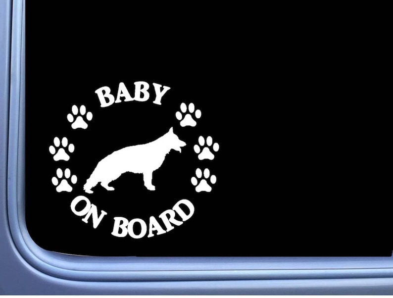May include: White vinyl decal with the text "Baby on Board" and a silhouette of a German Shepherd puppy. The decal is surrounded by paw prints.