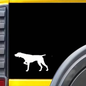 May include: White silhouette of a dog, possibly a German Shorthaired Pointer, on a black background. The dog is depicted in a walking pose, with one front leg raised. The image is likely a decal or sticker.