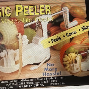 May include: A white Magic Peeler fruit and vegetable peeler with a crank handle, designed to peel, core, and slice. The image shows the peeler in use with various fruits and vegetables. The text reads "No More Hassle!"
