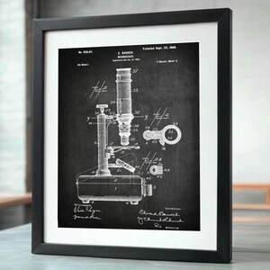 May include: Black and white vintage patent drawing of a microscope. The drawing shows the microscope's parts and details. The patent number is 618,815 and the date is Sept. 23, 1908. The text reads "E. Bausch Microscope Patented Sept. 23, 1908."