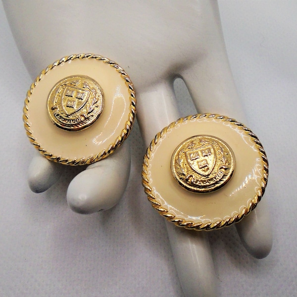 Vintage Gold Tone Detailed Crest Surrounded by Cream Enamel Round Chunky Clip Earrings Designer Signed Ellen Designs