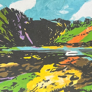 May include: A vibrant landscape painting featuring mountains, a lake, and sky. The mountains are depicted in black, green, and purple, with a lake in the foreground. The sky is blue with white clouds. The artwork uses bold colours and brushstrokes.