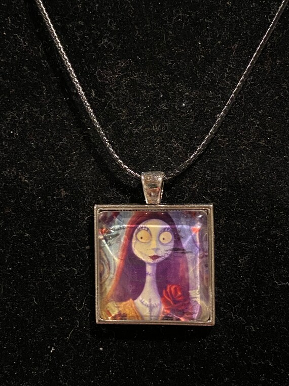 Sally round with a rose silver pendant necklace