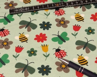 Jersey fabric the friends bee, butterfly and ladybug are out and about together in the flower meadow