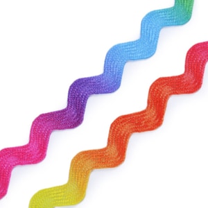 May include: Three zig-zag patterned ribbons in rainbow colors. The ribbons are arranged in a diagonal pattern, with the yellow and orange ribbon at the bottom, the red and purple ribbon in the middle, and the blue and green ribbon at the top.