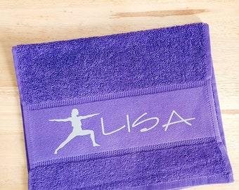 May include: Purple yoga towel with a white yoga silhouette and the name "LISA" embroidered on it.