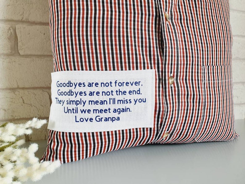 May include: A red and black striped pillow with a white patch that reads "Goodbyes are not forever. Goodbyes are not the end. They simply mean I'll miss you Until we meet again. Love Granpa"