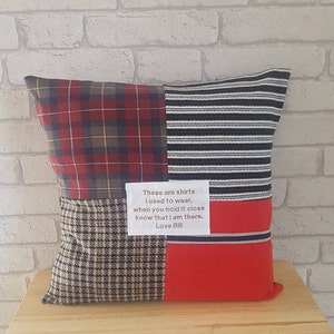 May include: A red, black, and white plaid pillow with a brown and white plaid section and a red section. The pillow has a white label with the text "These are shirts I used to wear, when you hold it close know that I am there. Love Bill."