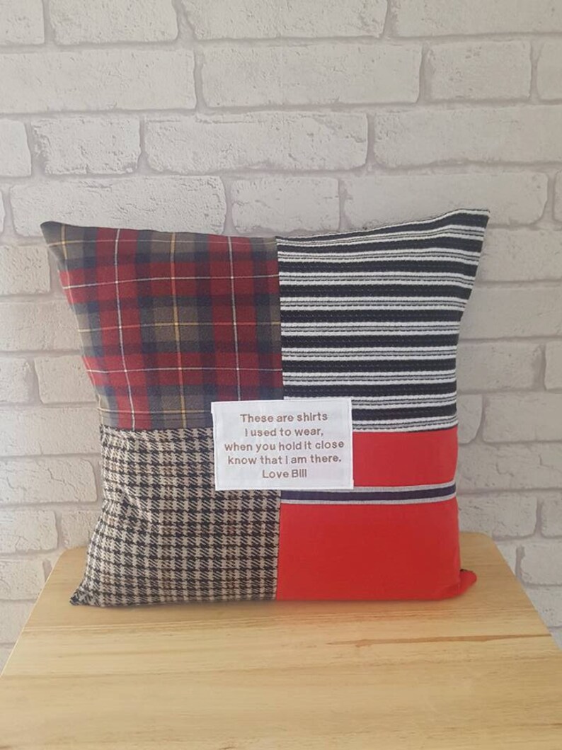May include: A red, black, and white plaid pillow with a brown and white plaid section and a red section. The pillow has a white label with the text "These are shirts I used to wear, when you hold it close know that I am there. Love Bill."