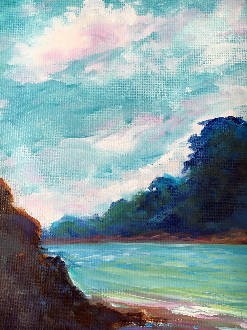 May include: An oil painting depicts a serene coastal scene. The sky is a blend of light blue, white, and pink hues, suggesting a sunrise or sunset. Lush green trees line the horizon, and the water is a vibrant turquoise. A rocky shoreline is in the foreground.