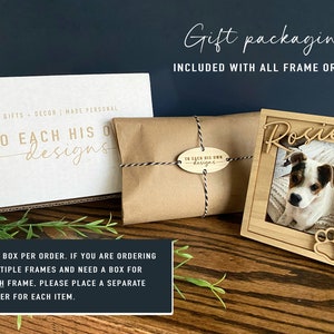 May include: A light-coloured wooden picture frame featuring the name Rosie in script and a paw print cutout, displayed with a white cardboard gift box and a brown paper-wrapped package tied with black and white twine, both branded with To Each His Own Designs.