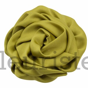 May include: A large, green fabric rose. The rose is made of soft, silky material and is perfect for adding a touch of elegance to any occasion.