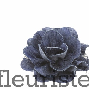 May include: A blue denim rose flower with a layered design. The flower is made of fabric and has a delicate, ruffled texture. The flower is perfect for adding a touch of rustic charm to any project.
