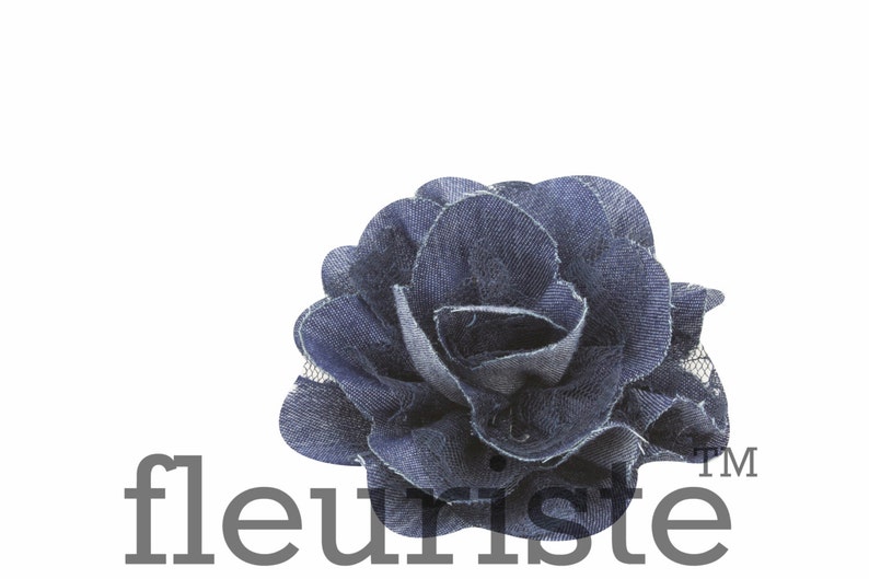 May include: A blue denim rose flower with a layered design. The flower is made of fabric and has a delicate, ruffled texture. The flower is perfect for adding a touch of rustic charm to any project.
