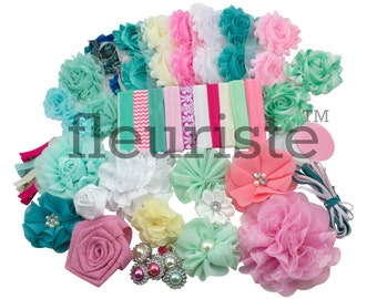 May include: A set of 15 baby headbands with various colors and styles. The headbands feature a variety of fabric flowers in shades of pink, green, and white. The headbands are made with elastic and are designed to fit a baby's head.