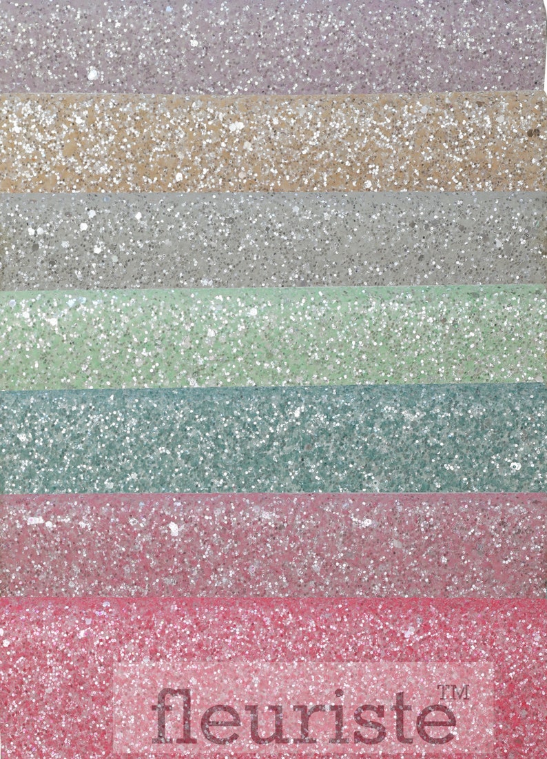 May include: Six strips of glitter fabric in various colors, including lavender, beige, silver, light green, teal, and pink. The fabric is textured with glitter and has a subtle sheen. The word "fleuriste" is printed in white at the bottom of the image.