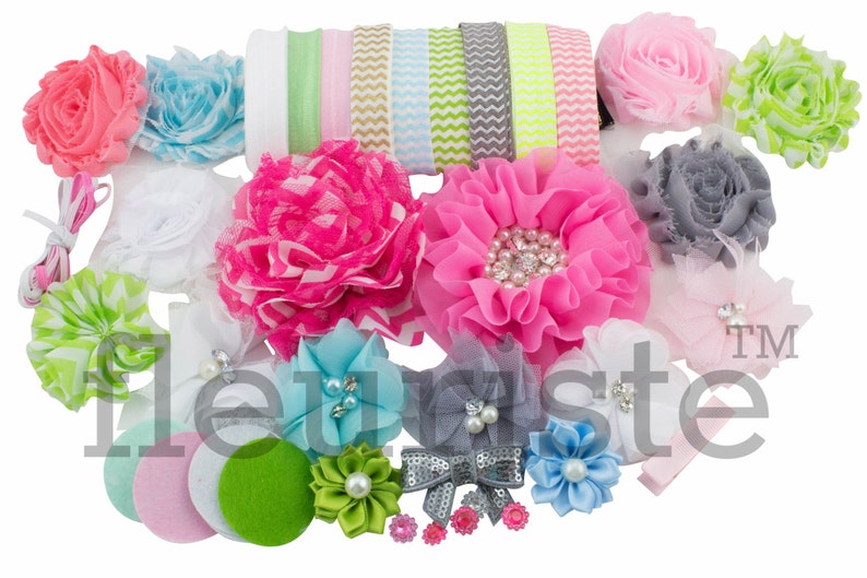 May include: A set of 18 hair accessories for babies and toddlers, featuring a variety of colors and styles, including flowers, ribbons, and headbands. The set includes pink, blue, green, white, and gray colors.