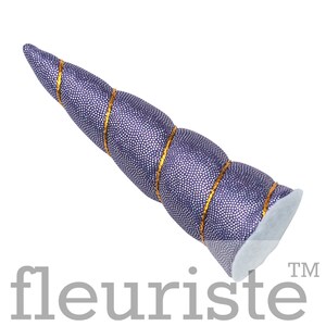 May include: Purple unicorn horn headband with gold glitter trim. The horn is made of fabric and is shaped like a spiral.