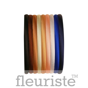 May include: A set of ten velvet headbands in various colors, including black, brown, beige, light brown, peach, pink, light blue, and dark blue.