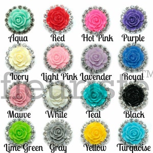 May include: Assortment of 16 rhinestone-embellished flower embellishments in various colours, including aqua, red, hot pink, purple, ivory, light pink, lavender, royal blue, mauve, white, teal, black, lime green, grey, yellow, and turquoise.