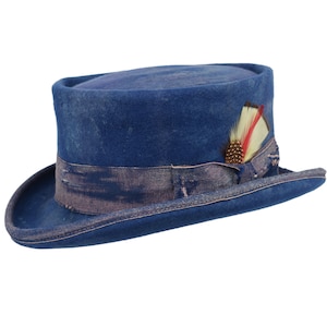 May include: A blue top hat with a pink ribbon and a feather accent. The hat has a distressed look, giving it a vintage feel.