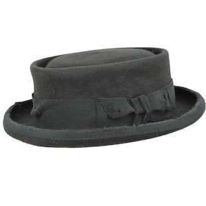 May include: A black felt fedora hat with a wide brim and a black ribbon around the crown.