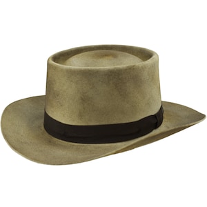 May include: A light brown fedora hat with a black band. The hat has a wide brim and a tall crown.