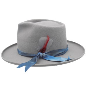 May include: A gray fedora hat with a blue ribbon tied in a bow at the front. The hat has a feather accent with red and white feathers.