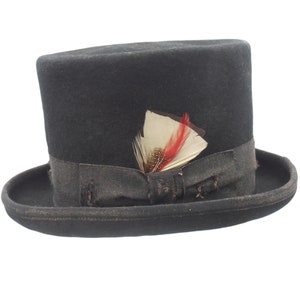May include: A black top hat with a black ribbon and a small red and white feather accent.