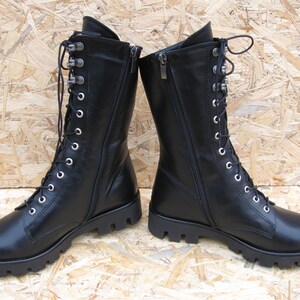 May include: Black leather lace-up boots with a side zipper and a chunky sole.