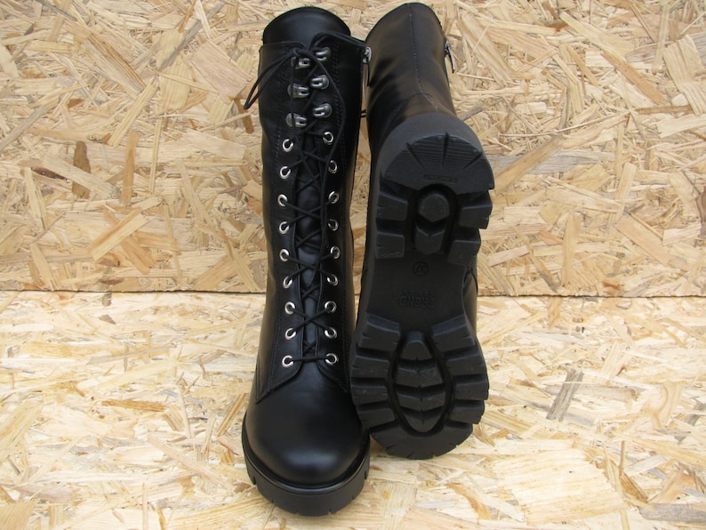 May include: Black leather lace-up boots with a chunky heel and a rubber outsole.