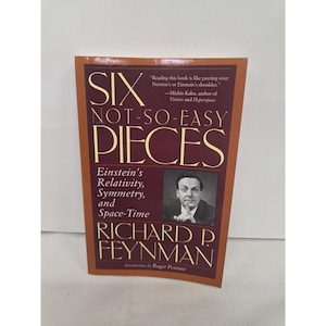 May include: A paperback book titled Six Not-So-Easy Pieces by Richard P. Feynman. The cover is dark red with gold text and features a black and white photograph of Feynman. It includes the subtitle Einstein's Relativity, Symmetry, and Space-Time.